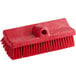 A Carlisle Sparta red floor scrub brush with bristles and a hole in the handle.