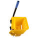 A yellow plastic wringer with black handles.