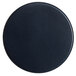 A round blue vinyl coaster with a black center on a table.