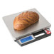 A Taylor digital receiving scale with a loaf of bread on it.