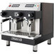An Astra Mega II Compact automatic espresso machine in black and silver. Two coffee cups sit on top.