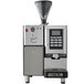 An Astra SM111 Super Mega I automatic coffee machine with a black and silver finish and a cup on it.