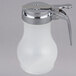 A white polypropylene Tablecraft syrup dispenser with a chrome plated metal top.
