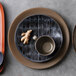 A tan World Tableware stoneware mug on a table.