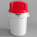 A white Rubbermaid BRUTE trash can with a red dome lid.