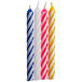 A group of Creative Converting assorted pastel spiral candles with stripes in blue, red, and white.