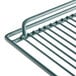 A close up of a Middle Gray coated wire shelf by Avantco.