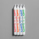 A pack of Creative Converting "Happy Birthday" spiral candles in assorted colors with writing on them.