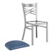 A Lancaster Table & Seating metal chair with a navy blue cushion on it.