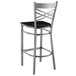 A Lancaster Table & Seating clear coat finish cross back bar stool with a black wood seat and black frame.