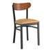 A Lancaster Table & Seating Boomerang Series black chair with a tan vinyl seat and wooden back.