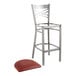 A Lancaster Table & Seating clear coat metal bar stool with a burgundy cushion.