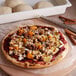 A table with a pizza made with DeIorio's frozen bread dough, nuts, and jam on it.