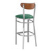 A Lancaster Table & Seating bar stool with a green vinyl seat and wood back.