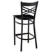 A black Lancaster Table & Seating cross back bar stool with a black wood seat.