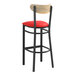 A black Lancaster Table & Seating bar stool with a red vinyl seat and driftwood back.