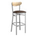 A Lancaster Table & Seating bar stool with a brown vinyl seat and driftwood back.