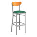 A Lancaster Table & Seating bar stool with a green vinyl seat and cherry wood back.