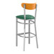 A Lancaster Table & Seating bar stool with a green vinyl seat and cherry wood back.