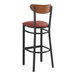 A Lancaster Table & Seating bar stool with a burgundy vinyl seat and wood back.