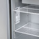 A Traulsen refrigerated sandwich prep table with open doors.