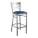 A Lancaster Table & Seating metal cross back bar stool with a navy blue cushion