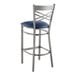 A Lancaster Table & Seating metal cross back bar stool with a navy blue cushioned seat.
