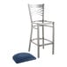 A Lancaster Table & Seating metal cross back bar stool with a navy cushion.