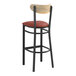 A Lancaster Table & Seating black bar stool with a burgundy vinyl seat and driftwood back.