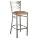 A Lancaster Table & Seating cross back bar stool with a light brown cushion on the seat.