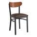 A Lancaster Table & Seating chair with a dark brown vinyl seat and wood back with a black finish.