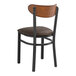 A Lancaster Table & Seating black chair with a dark brown cushioned seat and wooden back.
