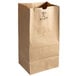 A bundle of brown Duro paper bags with a hole in the middle.