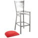 A Lancaster Table & Seating metal bar stool with a red cushion on a white background.