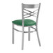 A Lancaster Table & Seating green vinyl padded cross back chair.