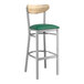 A Lancaster Table & Seating bar stool with a green vinyl seat and driftwood back.