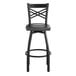 A Lancaster Table & Seating black cross back swivel bar stool with black wood seat.