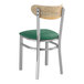 A Lancaster Table & Seating Boomerang chair with a green vinyl cushion.