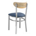 A Lancaster Table & Seating metal chair with a navy vinyl seat and driftwood back.