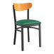 A Lancaster Table & Seating Boomerang Series black chair with a green vinyl seat.