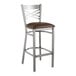 A Lancaster Table & Seating clear coat finish cross back bar stool with a dark brown cushion.