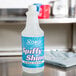 A bottle of Noble Chemical Spiffy Shine liquid metal polish on a counter.