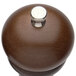 A Chef Specialties Windsor walnut pepper mill with a silver top.