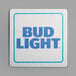 A white square paper coaster with a blue and white Bud Light logo.