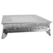 A silver rectangular Tabletop Classics by Walco cake stand with floral designs and feet.