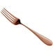 A close-up of a Reserve by Libbey Santa Cruz Copper Dinner Fork with a rose gold handle.