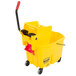 A Rubbermaid yellow mop bucket with a handle and red dirty water bucket.