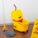 A yellow Rubbermaid WaveBrake mop bucket with a red wringer.