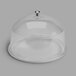 A clear acrylic dome with a metal knob.