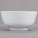 A close-up of a white GET Water Lily melamine bowl.